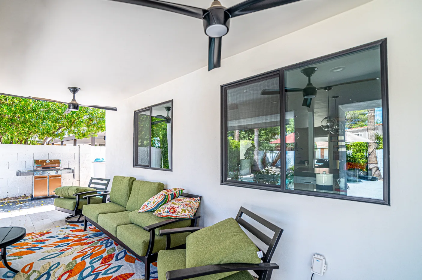 Completed covered patio with coordinated windows and outdoor living space