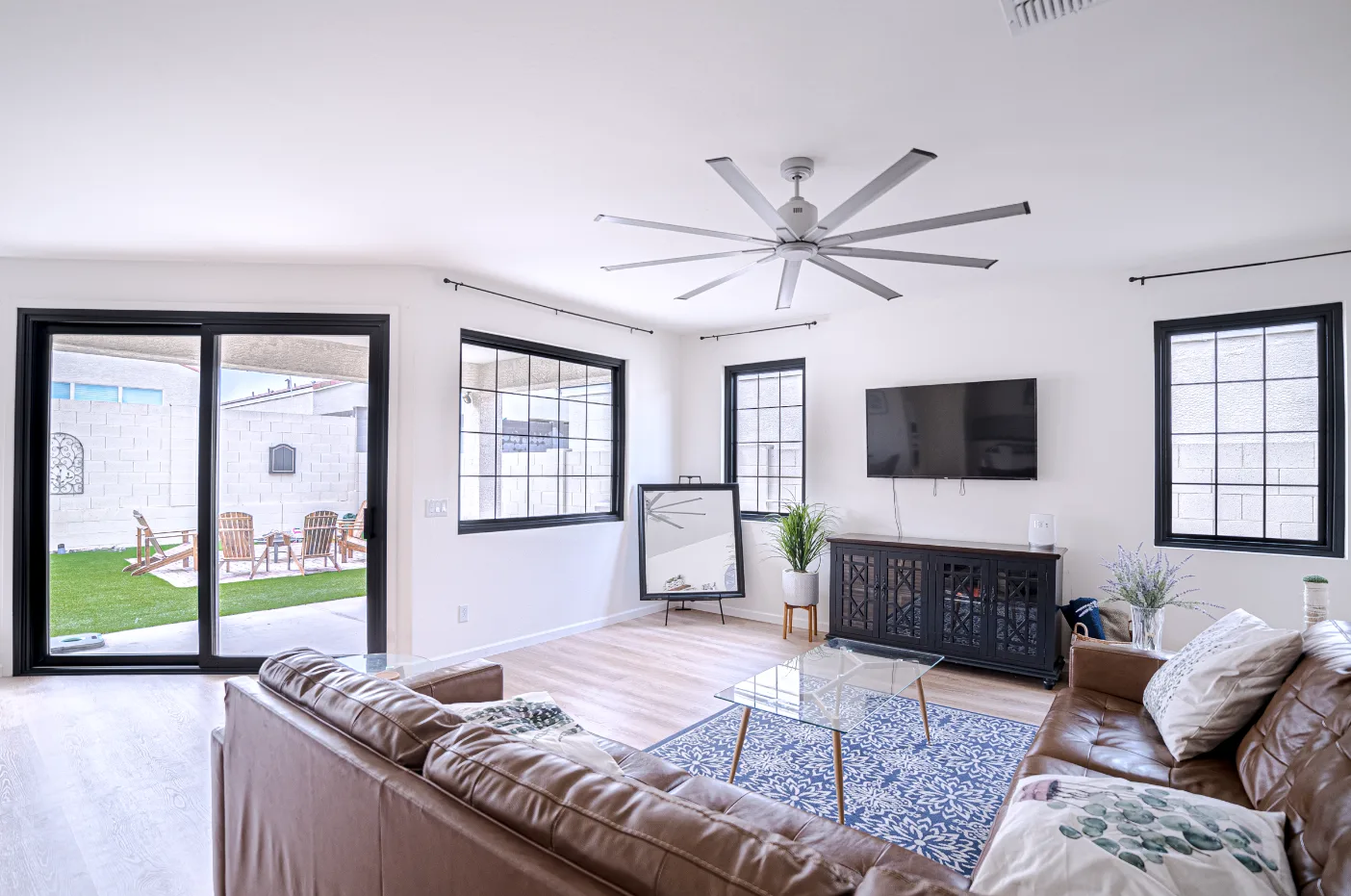 Modern living room with several windows and a glazed exterior door