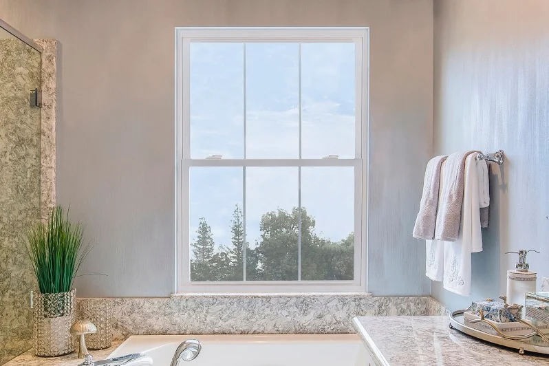 Installed Anlin Coronado hung window above a bathtub
