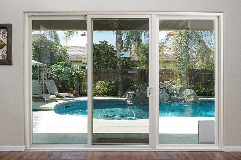 Installed Anlin Malibu three-panel patio door overlooking a pool