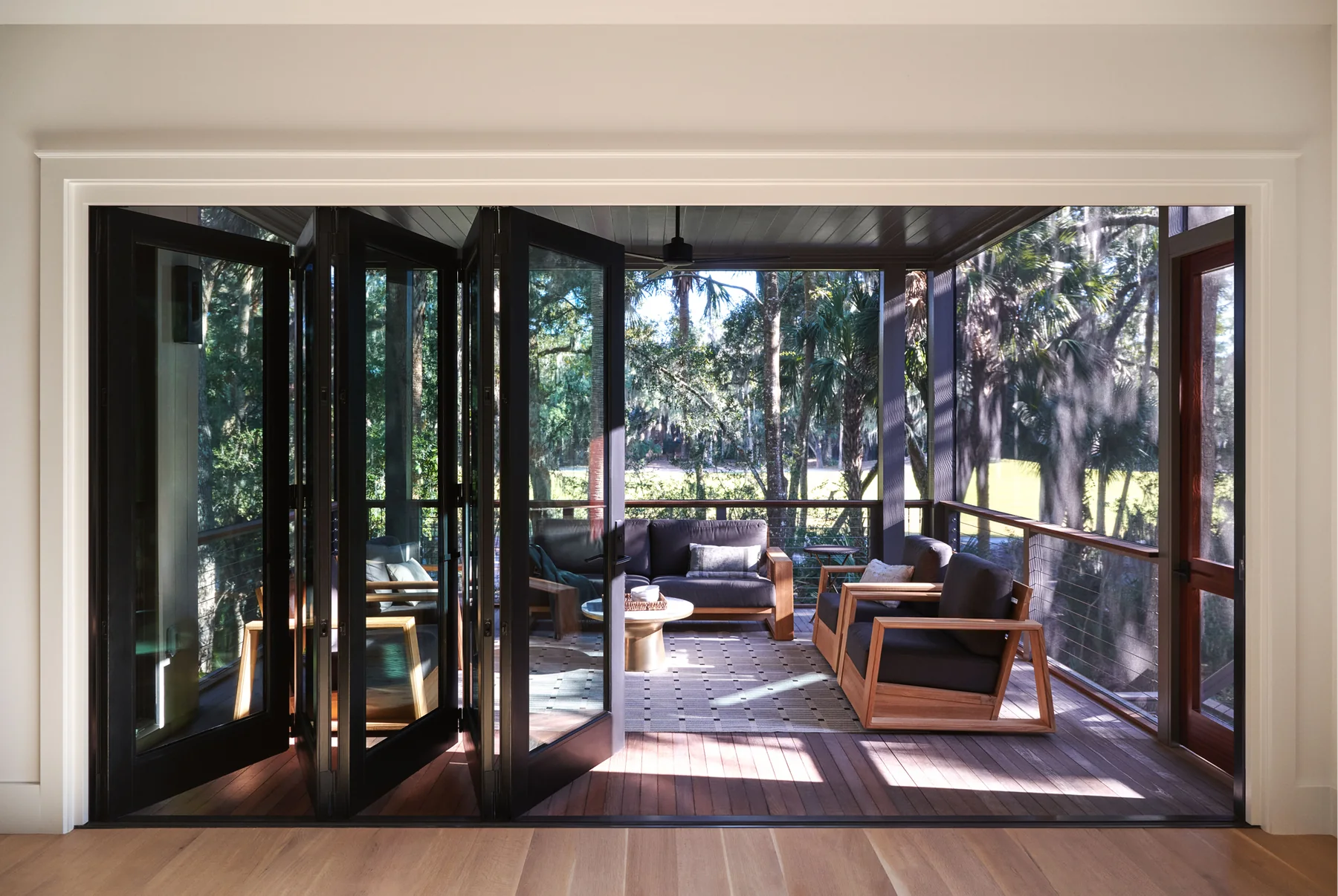 Bi-fold door panels opened toward an outdoor area