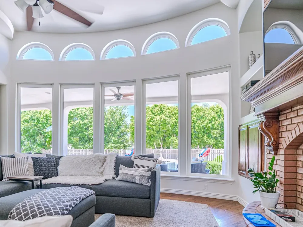Curved wall of white Sonoran picture and specialty windows