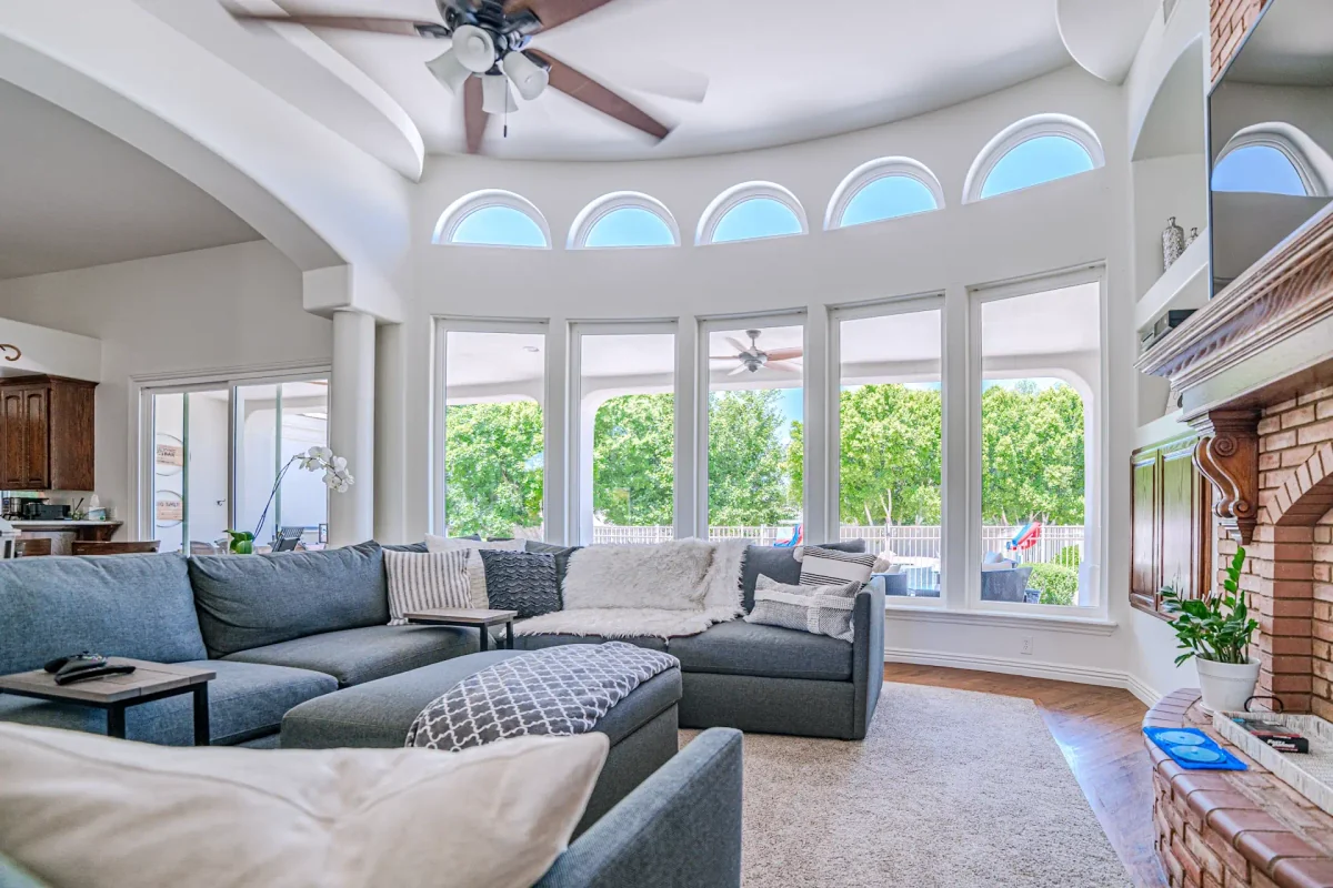 Bright living room framed by a wall of windows